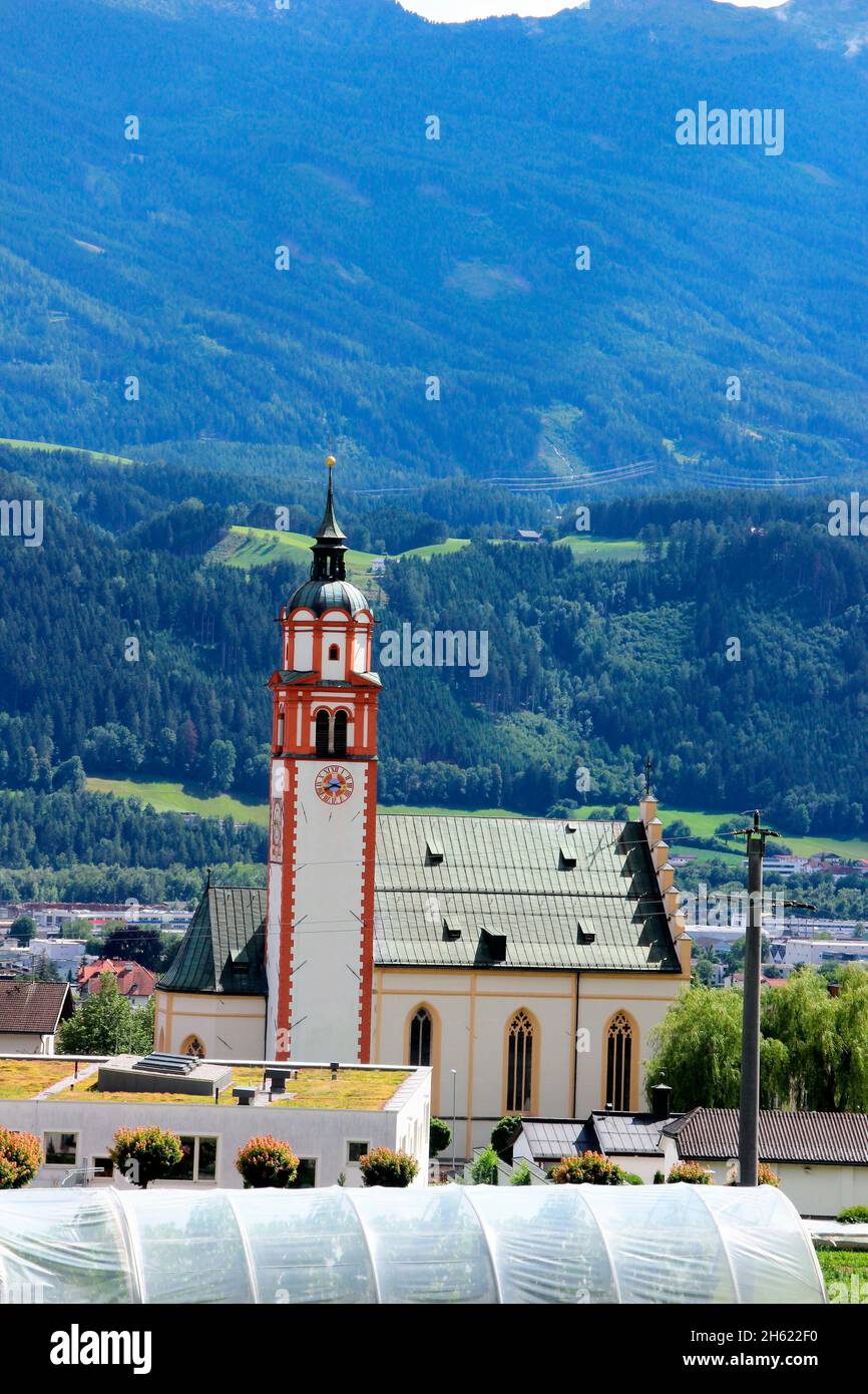 austria,tyrol,absam,town view,europe,mountains,mountain chain,alps,locality,houses,residential houses,plant house,church,meadows,fields,trees,blossom,season,summer, Stock Photo