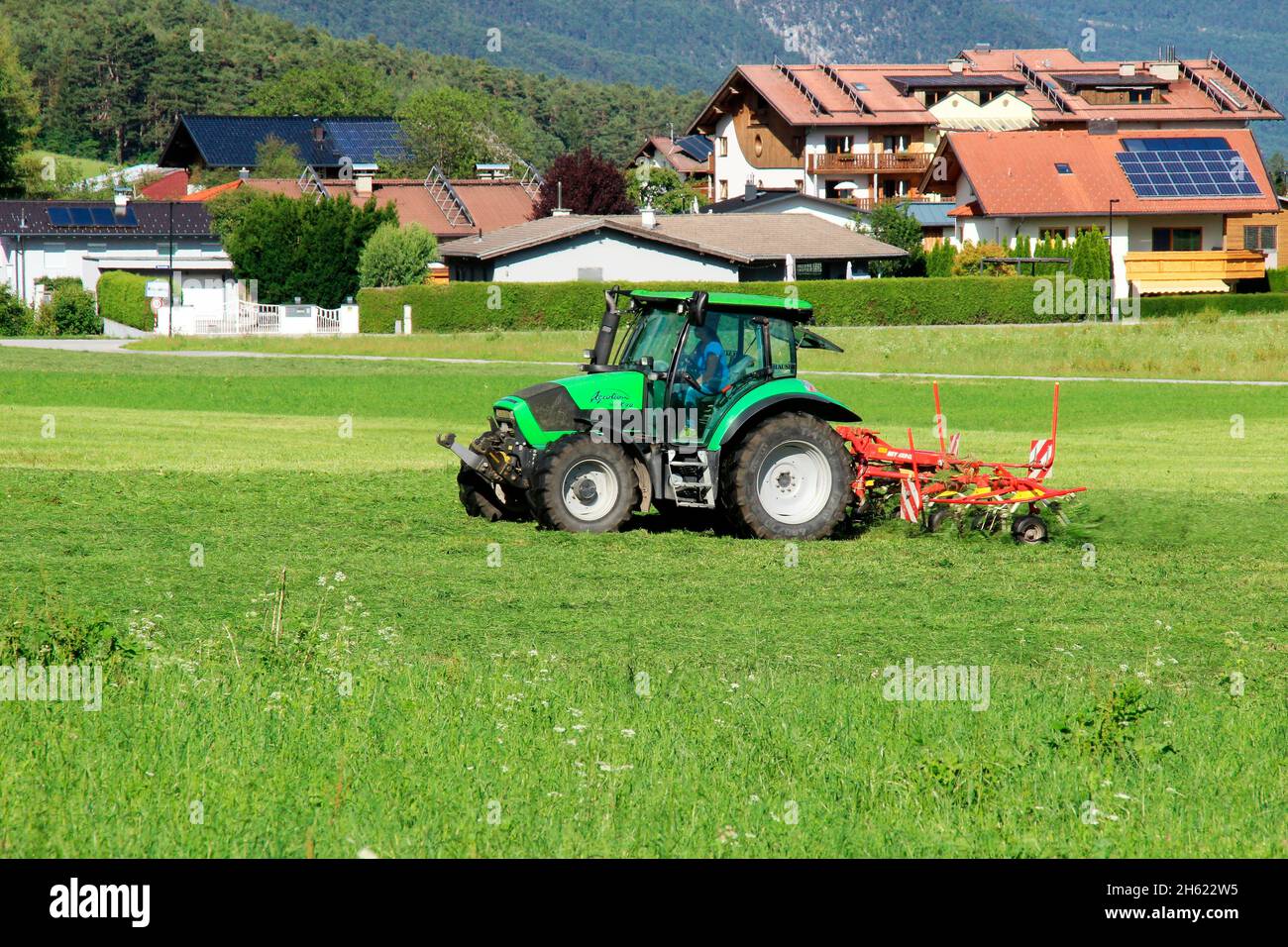 tractor,agrotron k 90,61.8 kw,84 ps,smallest model of the first agrotron k series introduced in 2005 by deutz-fahr with rotary haymaker,austria,tyrol,wildermieming, Stock Photo