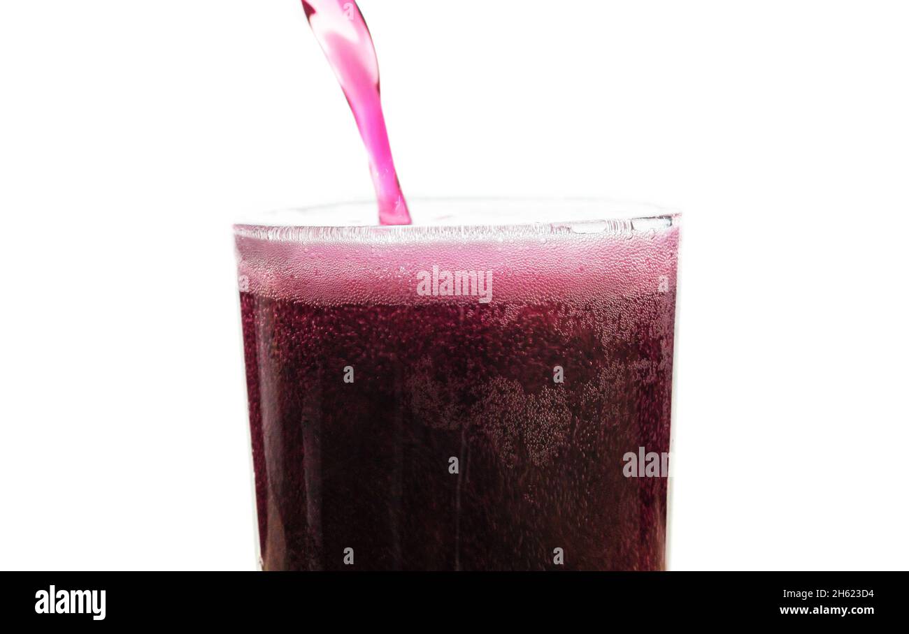 Solt drink being poures into a glass with ice Stock Photo
