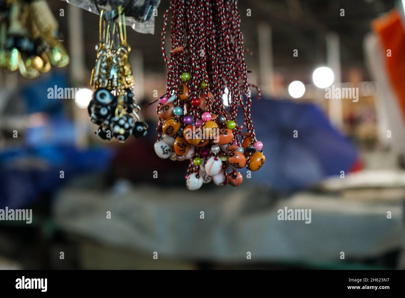 Evil eye beads and red chill pepper amulet. Close up shot with nice bokeh effect Stock Photo Alamy