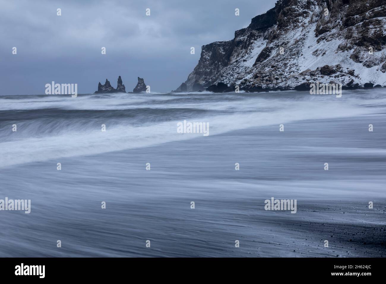 the coast in front of vik with a view of the sea stacks. Stock Photo