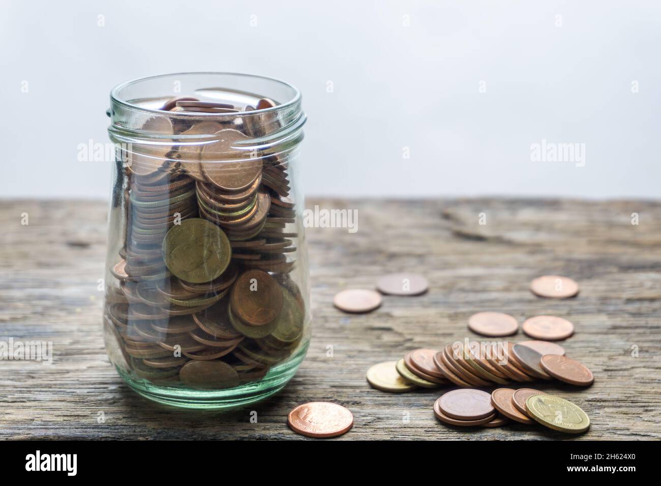 Save money and account banking for finance concept, Hand with coin on blurred background Stock Photo