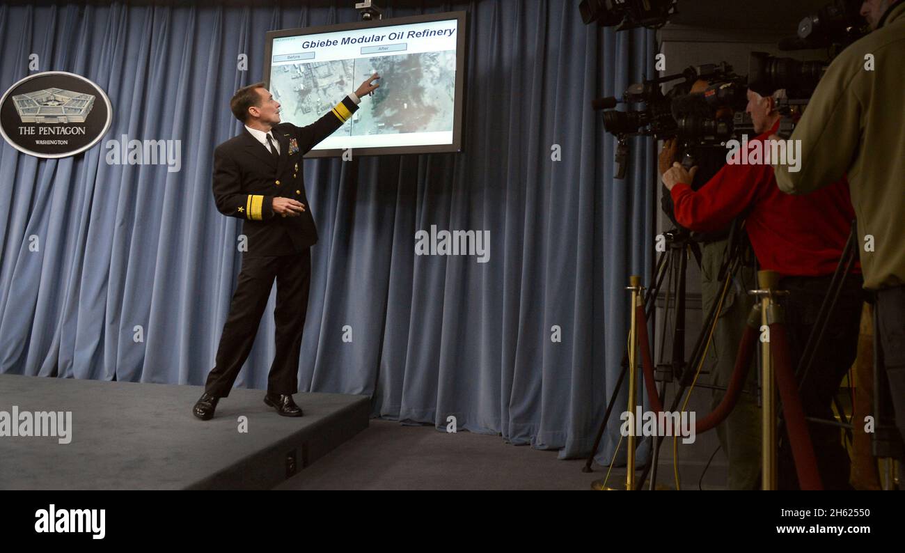 U.S. Navy Rear Adm. John Kirby, the Pentagon press secretary, holds a news briefing at the Pentagon in Arlington, Va., Sept. 25, 2014, about military efforts against extremists known as the Islamic State in Iraq and the Levant (ISIL). Kirby showed slides and videos highlighting U.S. airstrikes on ISIL targets in Syria and answered questions from reporters. President Barack Obama authorized humanitarian aid deliveries to Iraq as well as targeted airstrikes to protect U.S. personnel from ISIL. U.S. Central Command directed the operations. Stock Photo