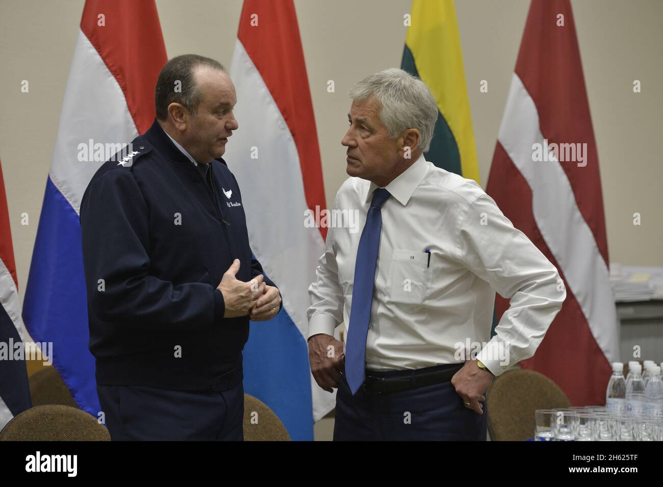Supreme Allied Commander Europe U.S. Air Force General Philip Breedlove, left, speaks with Secretary of Defense Chuck Hagel during a meeting of NATO defense ministers Feb. 26, 2014 Stock Photo