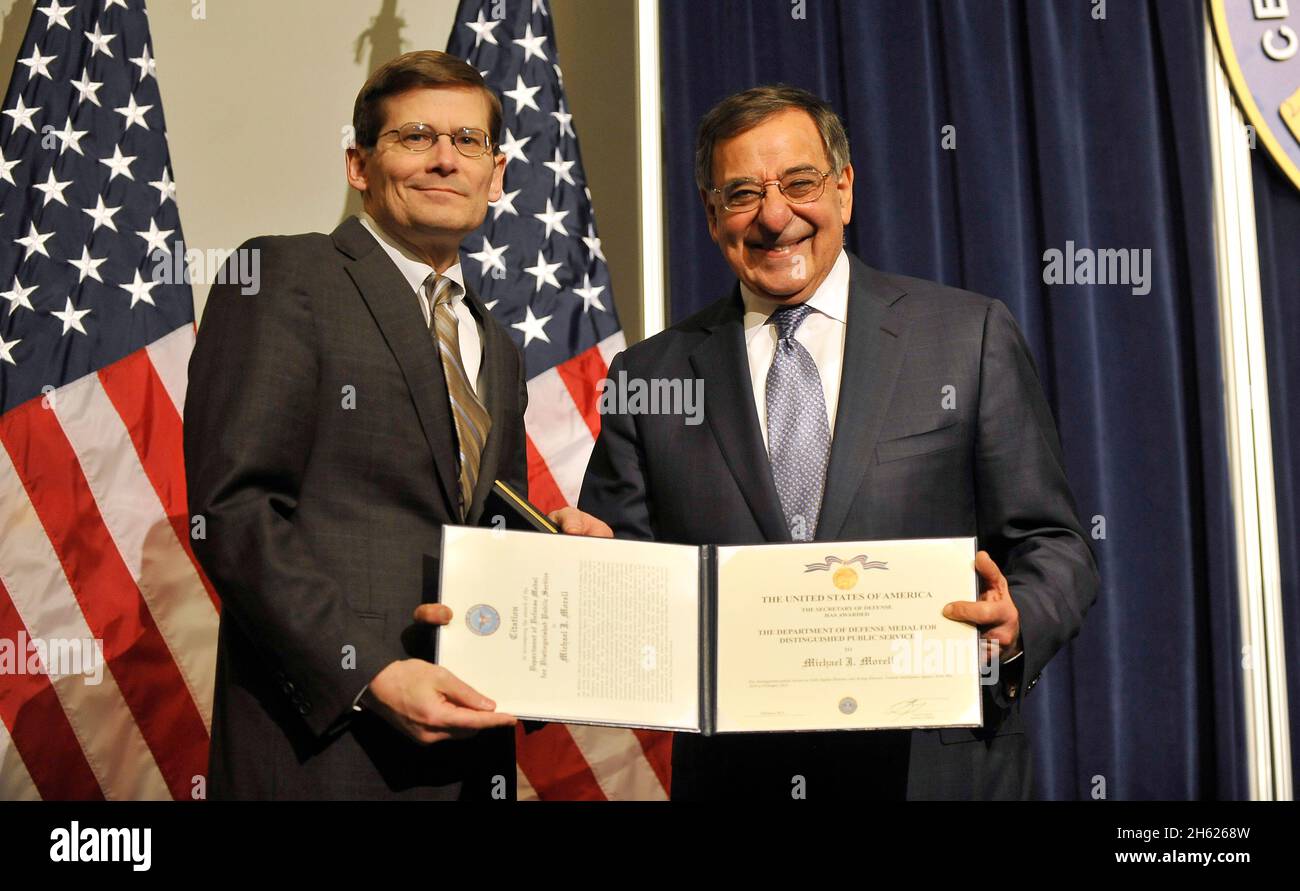 Secretary of Defense Leon Panetta presents an award to Michael Morell, acting director of the CIA, on final visit to the CIA Feb. 14, 2013. Stock Photo