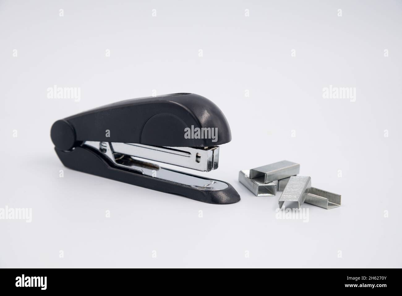 stapler with staple paper.A stapler is a mechanical device that joins