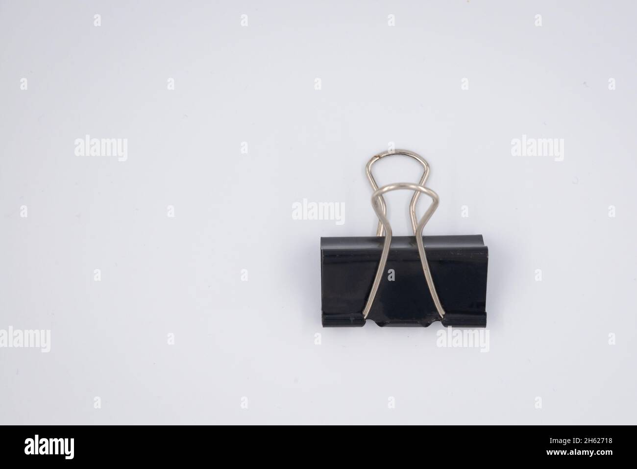 Black Paper clip isolated on white background. Stock Photo