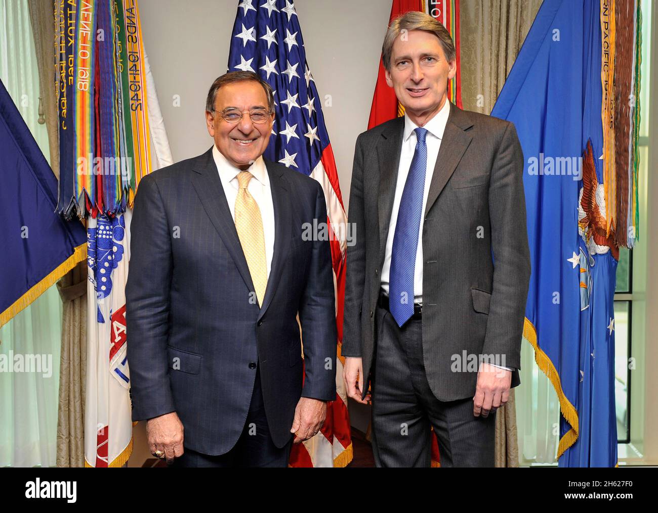Secretary of Defense Leon E. Panetta, left, poses for the formal photo with the flags as he greets Secretary of State for Defence of the United Kingdom, The Right Honourable Philip Hammond MP at the Pentagon. Panetta and Hammond came together to sign a statement of intent of the Enhanced Cooperation on Carrier Operations and Maritime Power Projection. Stock Photo
