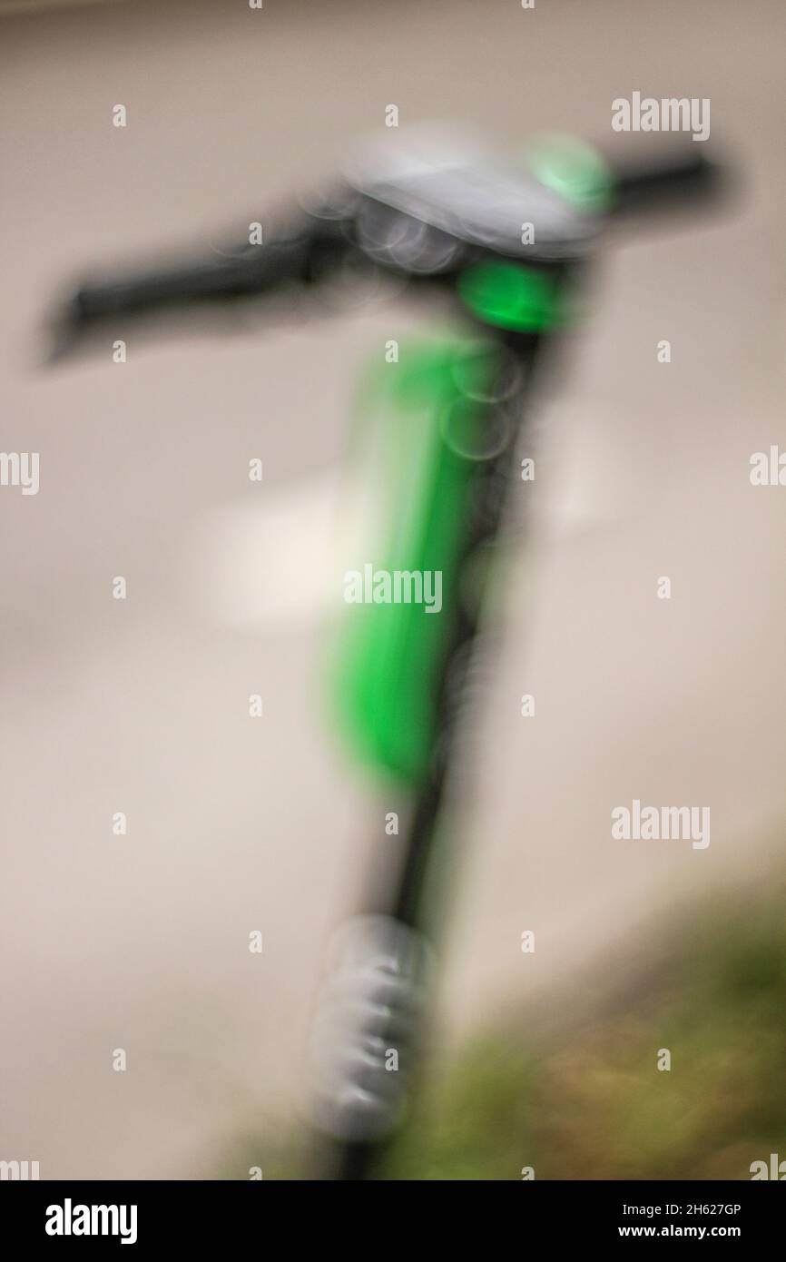 parked electric scooter on the roadside,e-scooter,abstract blur Stock Photo