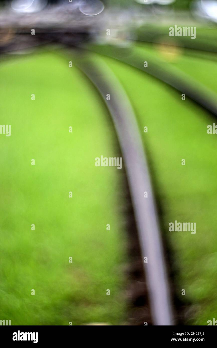 rails of the light rail in the green track bed,abstract blur Stock Photo