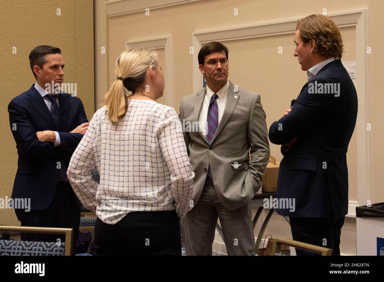Reportage:  U.S. Secretary of Defense Dr. Mark T. Esper speaks with the director of the Cybersecurity and Infrastructure Security Agency, Christopher C. Krebs, before delivering remarks at CISAâ€™s 2nd annual national cybersecurity summit, National Harbor, Maryland, Sept. 19, 2019. Stock Photo