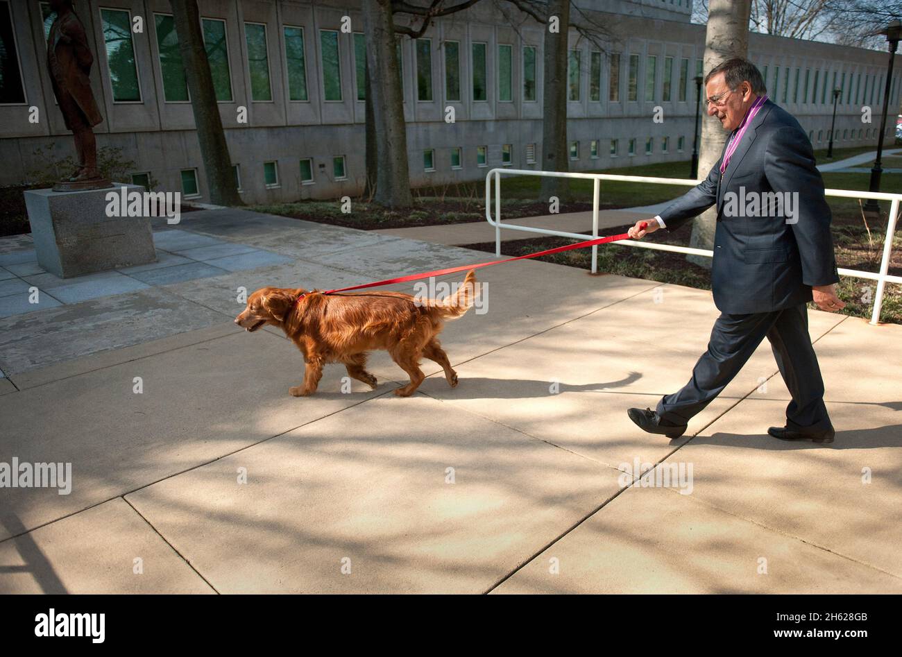 Secretary of Defense Leon E. Panetta walks his dog, Bravo, on the grounds of CIA headquarters in Langley, Va., Feb. 14, 2013. Stock Photo