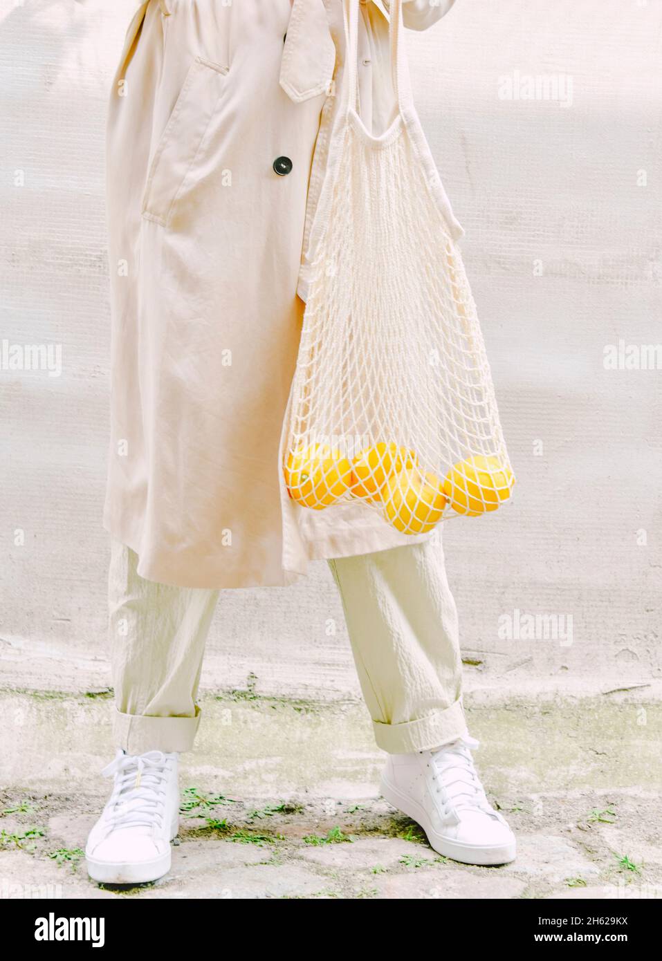 woman carries lemons in a shopping bag Stock Photo