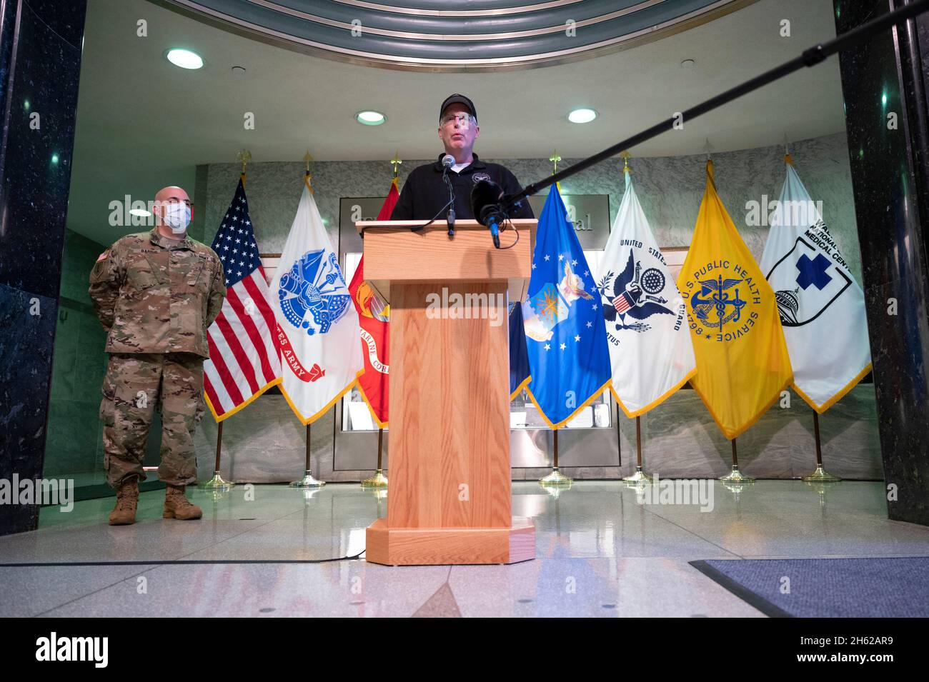 Reportage:  Acting Defense Secretary Chris Miller, with the director of the Walter Reed National Military Medical Center, Army Col. Andrew Barr, delivers remarks at the medical center before receiving a vaccination for COVID-19, Bethesda, Md., Dec. 14, 2020. Stock Photo