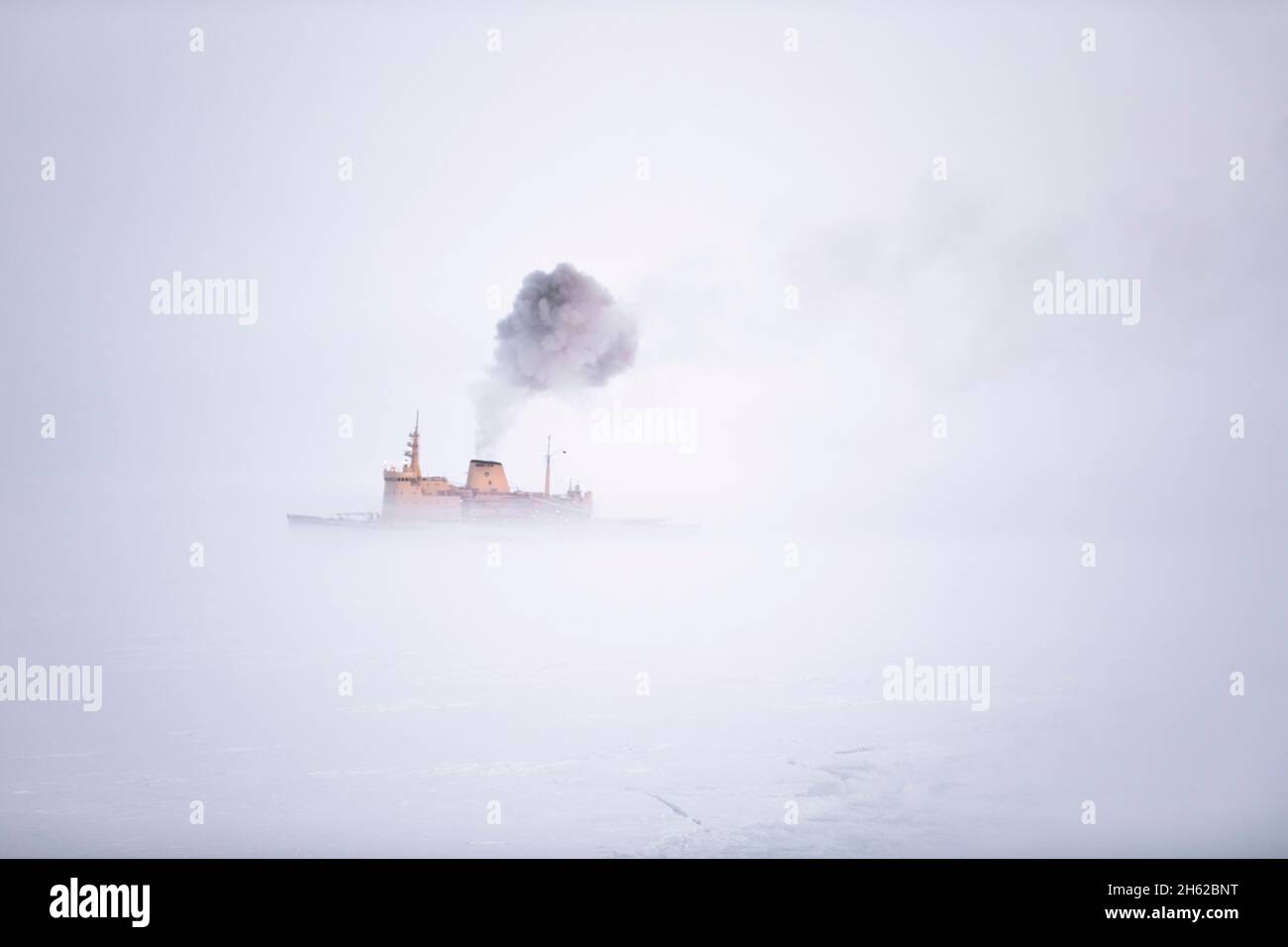 in march 2020,the icebreaker admiral makarov arrived north of franz josef land to refuel the icebreaker kapitan dranitsyn on its way back from the mosaic expedition. the exhaust fumes served as condensation nuclei and caused a thick fog to built around the ship. Stock Photo
