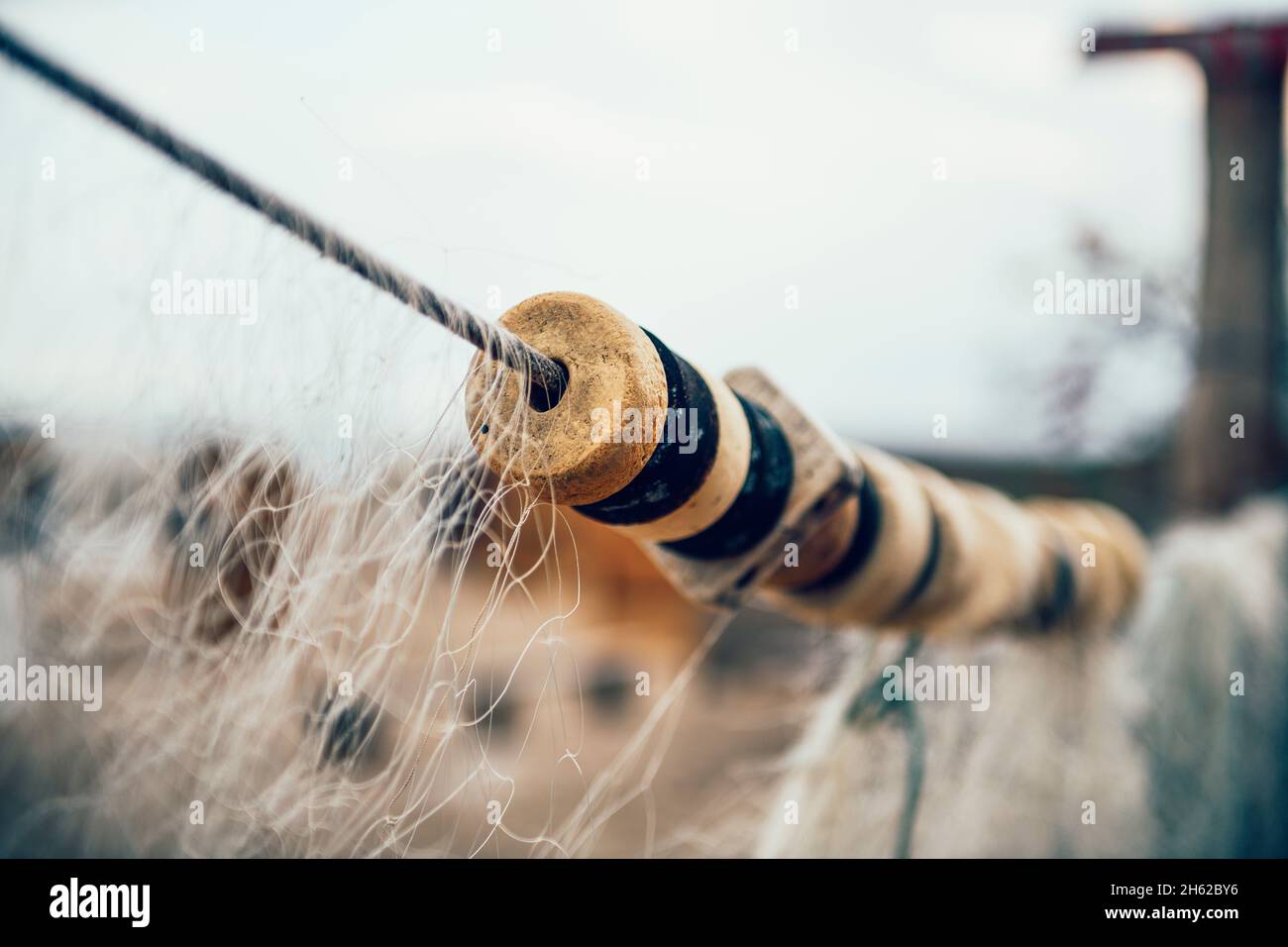 detail of a fishing net while drying on the beach Stock Photo
