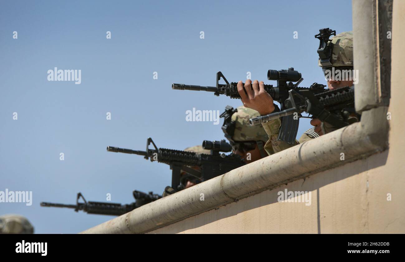 Troops keep a watchful eye on the perimeter of the U.S. Consulate in Herat, Afghanistan a day after it was attacked by the Taliban incurring heavy damage ca. 9/14/2013 Stock Photo