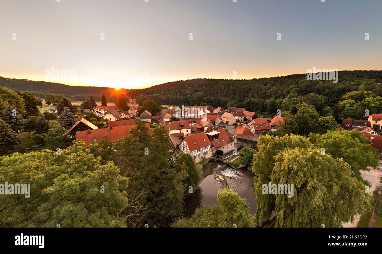 germany,thuringia,mellingen,buchfart,village,houses,river,weir,water wheel,covered wooden bridge,sunrise,back light,overview Stock Photo