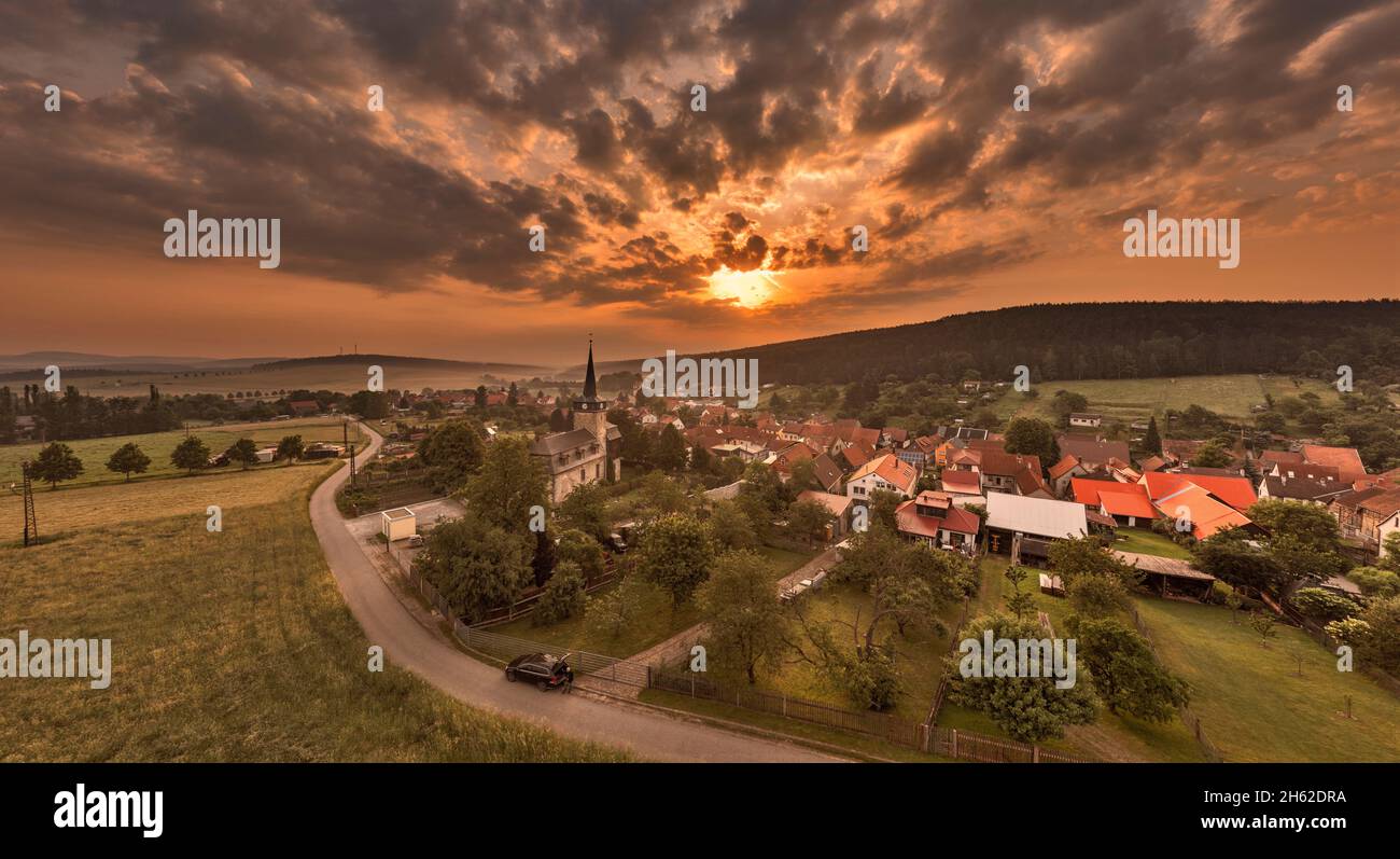 germany,thuringia,ilmenau,bücheloh,church,village,overview,sunrise,sun shines through thin layer of cloud,back light Stock Photo