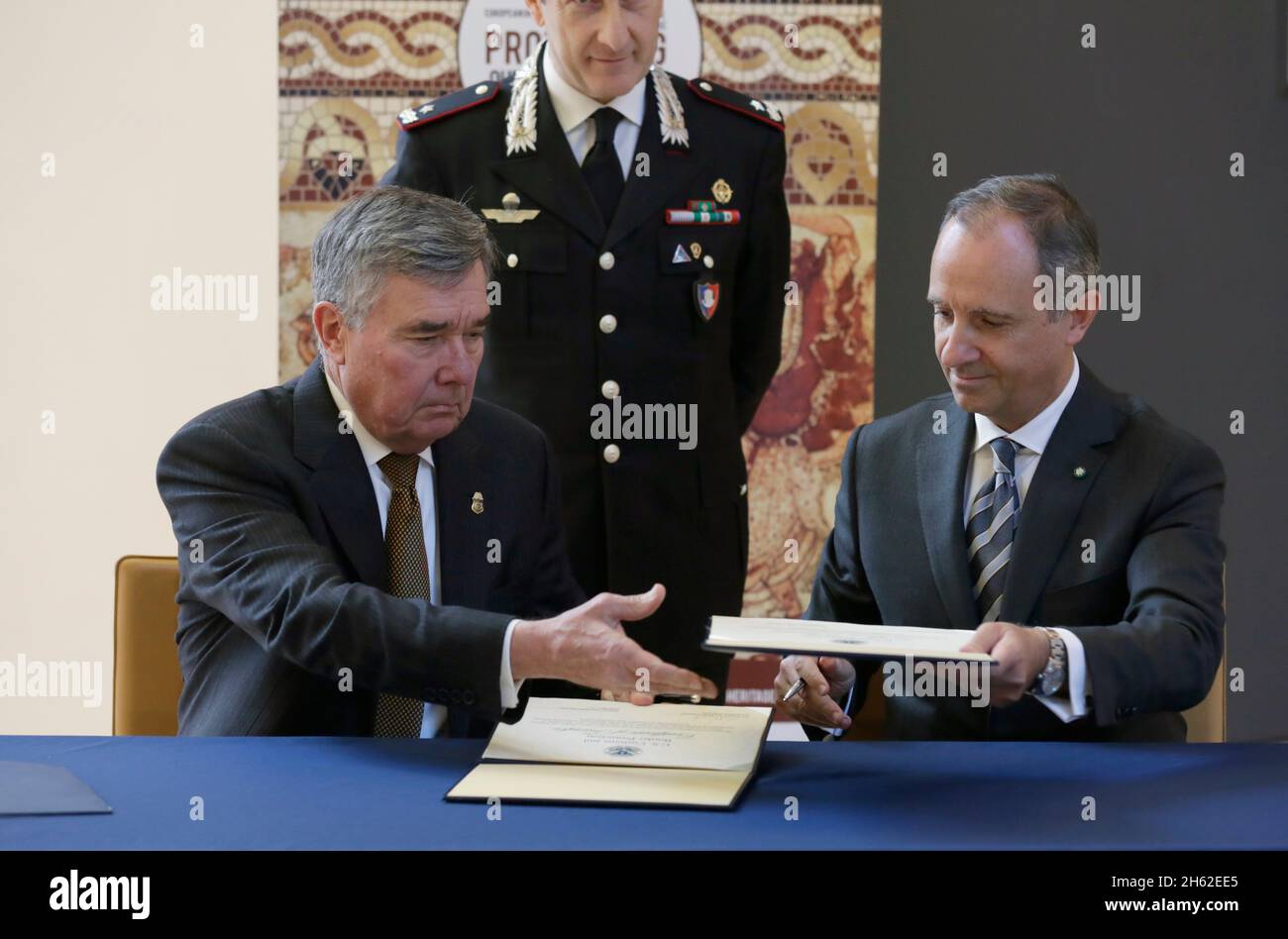 U.S. Customs and Border Protection Commissioner R. Gil Kerlikowske and Italian Ambassador to the United States Ambassador Armando Varricchio swap formal documents during a ceremony repatriating historic artifacts to the government of Italy at the Italian Embassy in Washington, D.C., December 9, 2016 Stock Photo