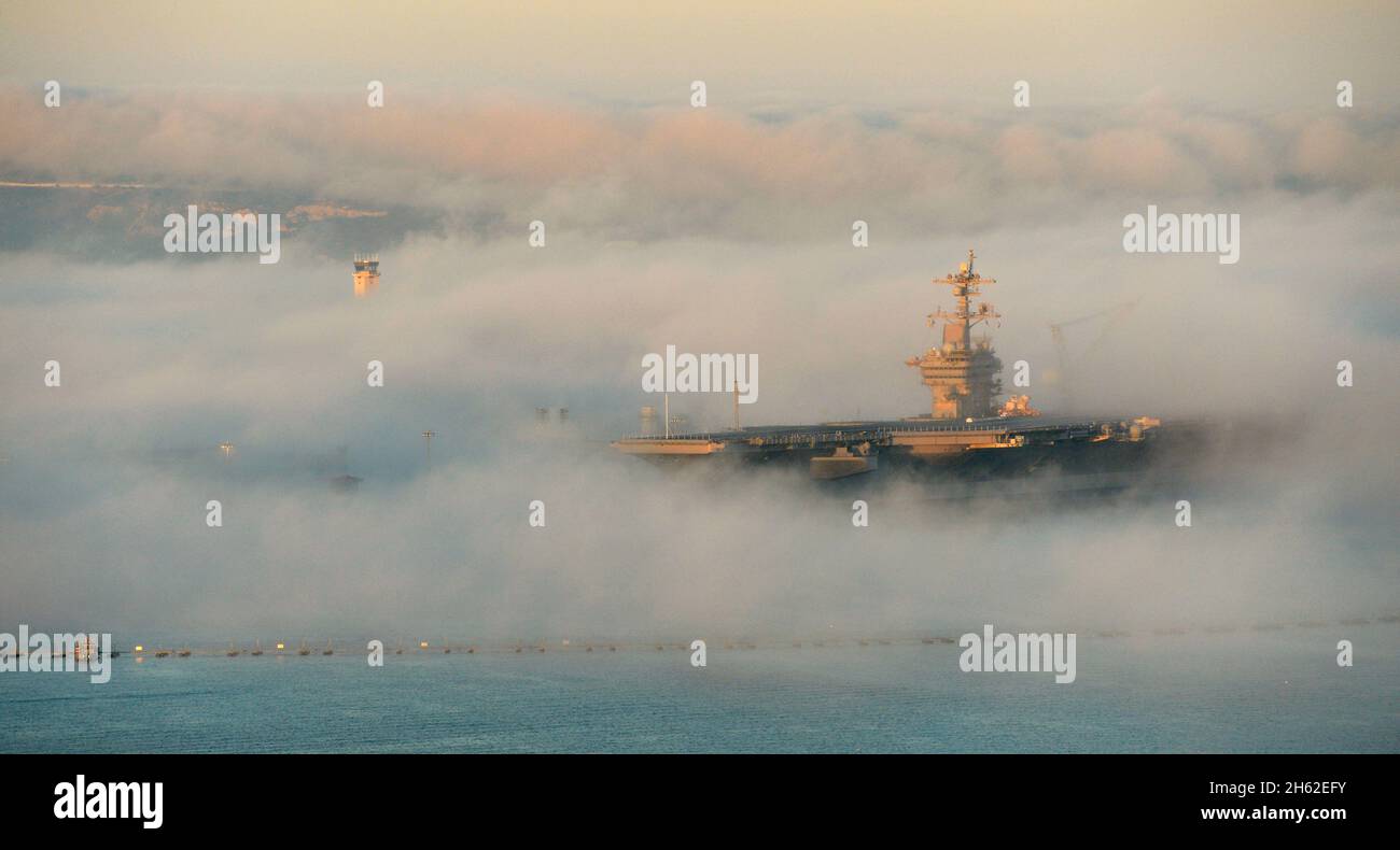 The USS Carl Vinson (CVN 70) is enveloped in fog as she sits at her berth in San Diego, Calif., Feb. 11, 2014. Stock Photo