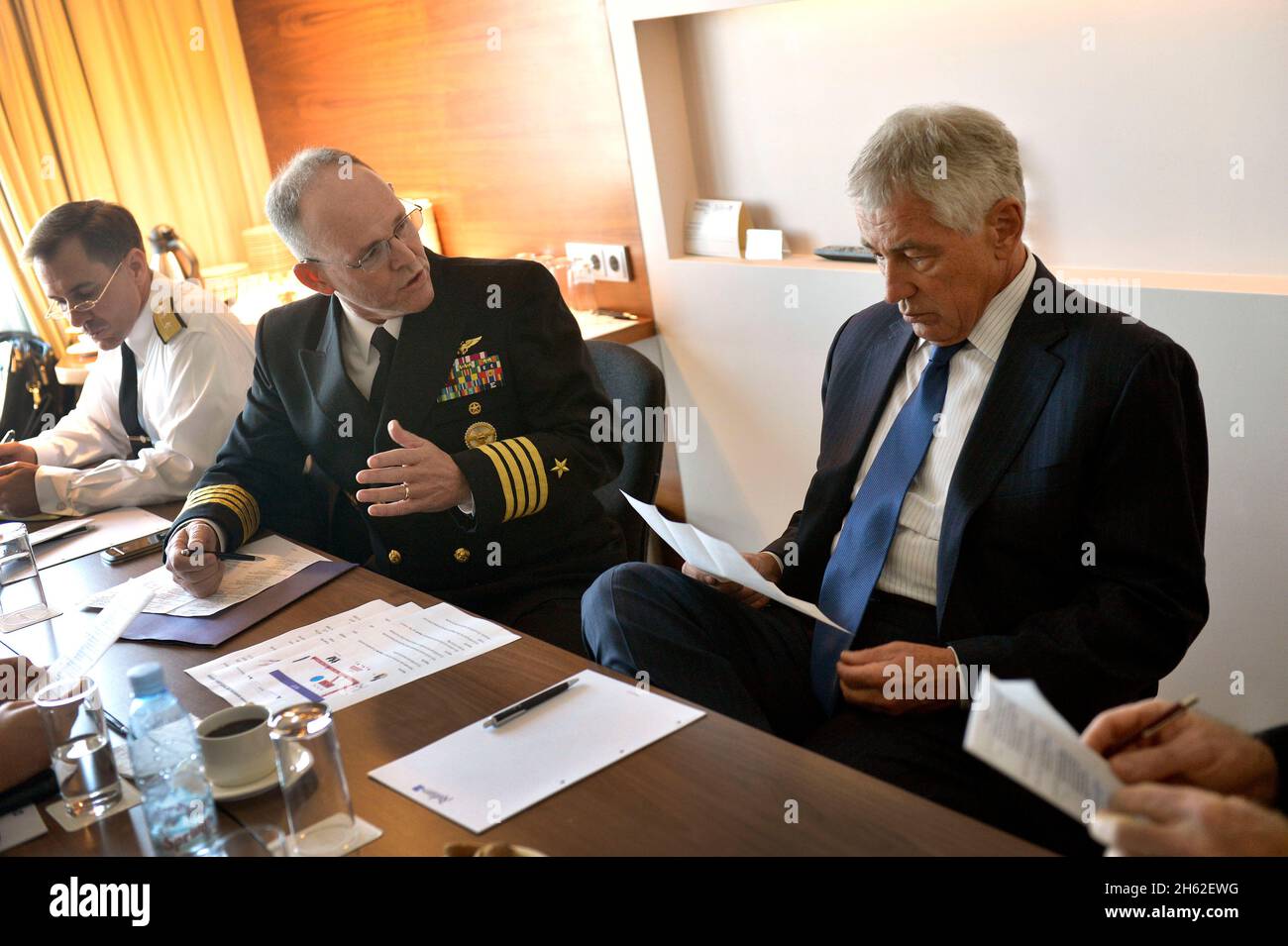 U.S. Navy Capt. Bill Cox, center, briefs Secretary of Defense Chuck Hagel, right, as he prepares to visit senior governmental officials in Tbilisi, Georgia, Sept. 7, 2014. Stock Photo