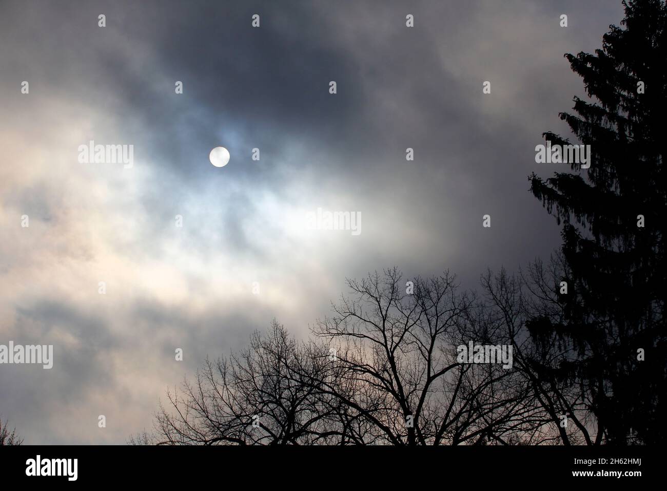 Autumn Morning Sky with the sun obscured by Clouds Stock Photo