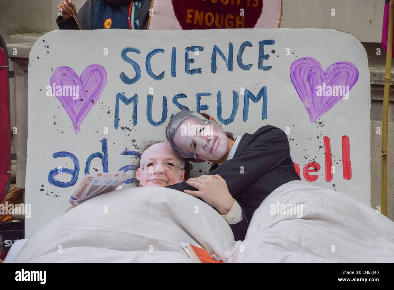 London, UK. 12th Nov, 2021. Protesters dressed as Science Museum director Ian Blatchford and Shell CEO Ben van Beurden lay in a bed during the demonstration.Extinction Rebellion demonstrators gathered outside the Science Museum in South Kensington, as part of their ongoing protests against sponsorship of the museum by fossil fuel companies Shell and Adani. (Photo by Vuk Valcic/SOPA Images/Sipa USA) Credit: Sipa USA/Alamy Live News Stock Photo