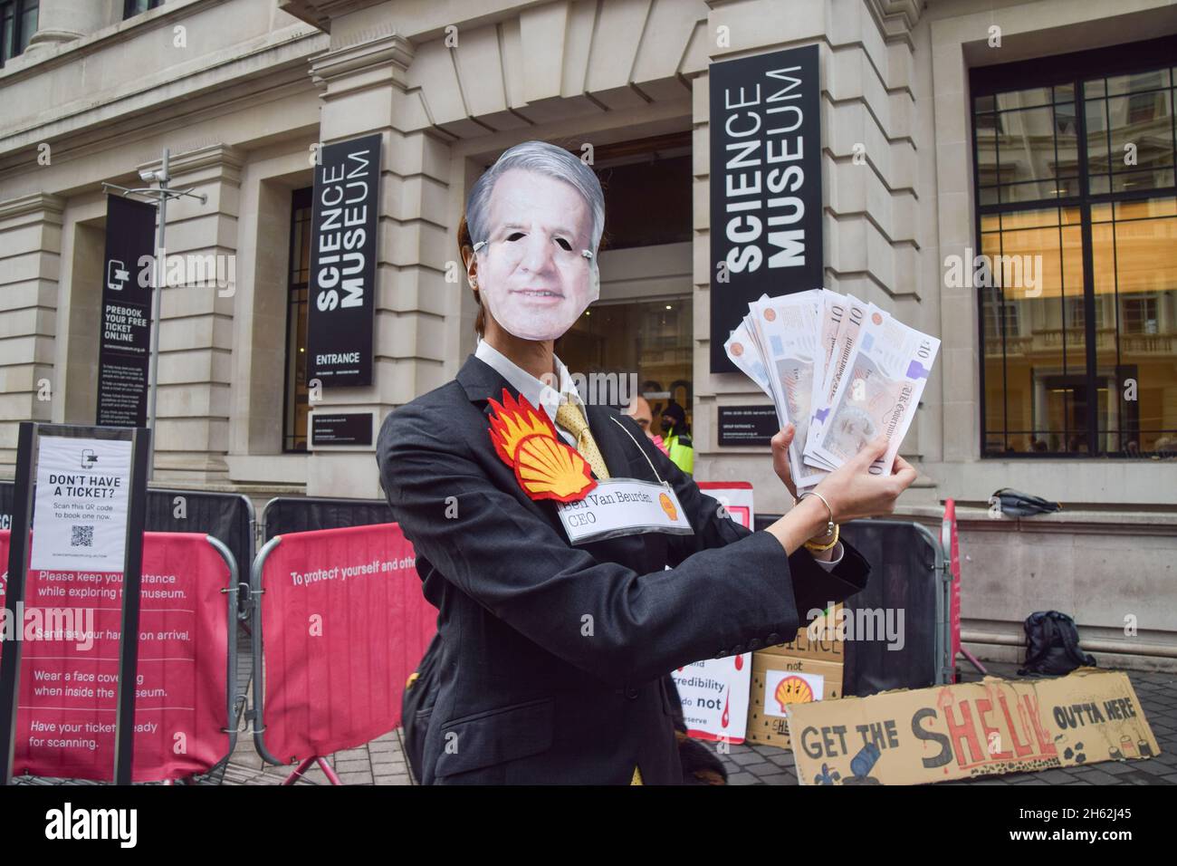 London, UK. 12th Nov, 2021. A protester dressed as Shell CEO Ben van Beurden holds fake money during the demonstration.Extinction Rebellion demonstrators gathered outside the Science Museum in South Kensington, as part of their ongoing protests against sponsorship of the museum by fossil fuel companies Shell and Adani. (Photo by Vuk Valcic/SOPA Images/Sipa USA) Credit: Sipa USA/Alamy Live News Stock Photo