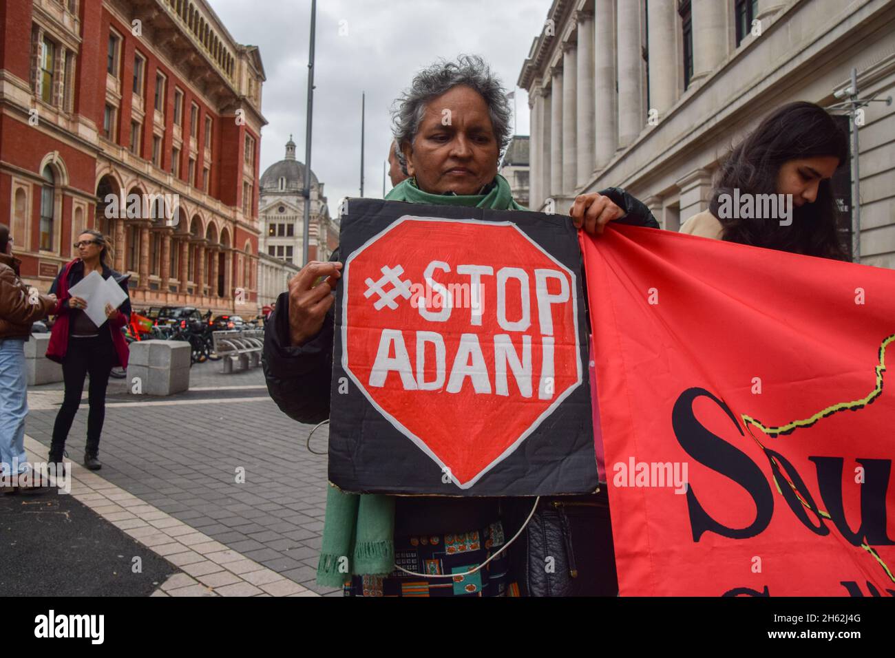 London, UK. 12th Nov, 2021. A protester holds a 'Stop Adani' placard expressing her opinion during the demonstration.Extinction Rebellion demonstrators gathered outside the Science Museum in South Kensington, as part of their ongoing protests against sponsorship of the museum by fossil fuel companies Shell and Adani. (Photo by Vuk Valcic/SOPA Images/Sipa USA) Credit: Sipa USA/Alamy Live News Stock Photo