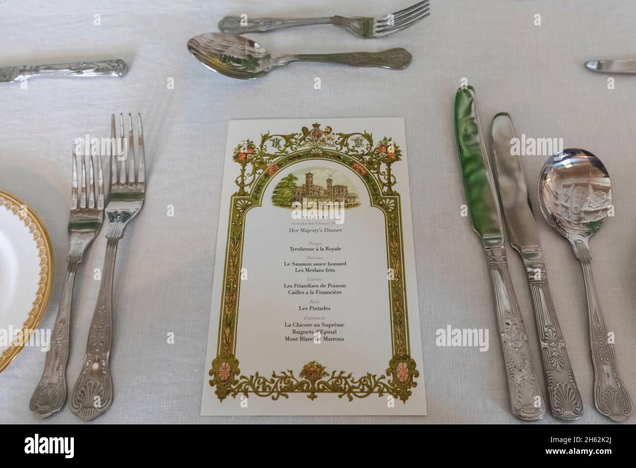 england,isle of wight,east cowes,osborne house,the palatial former home of queen victoria and prince albert,the durbar room,dining table place setting with her majesty's dinner menu in french Stock Photo