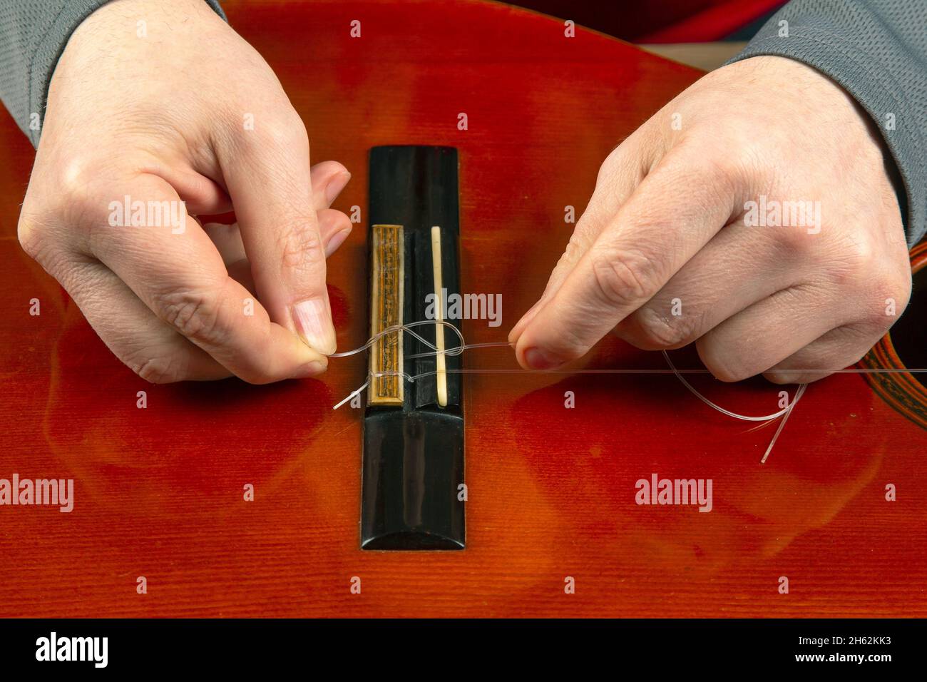 replacement and insertion of nylon strings in a classical guitar