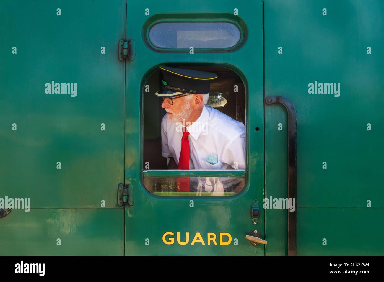 england,hampshire,ropley,ropley station,the mid-hants heritage railway aka the watercress line,train guard looking out of train carriage window Stock Photo