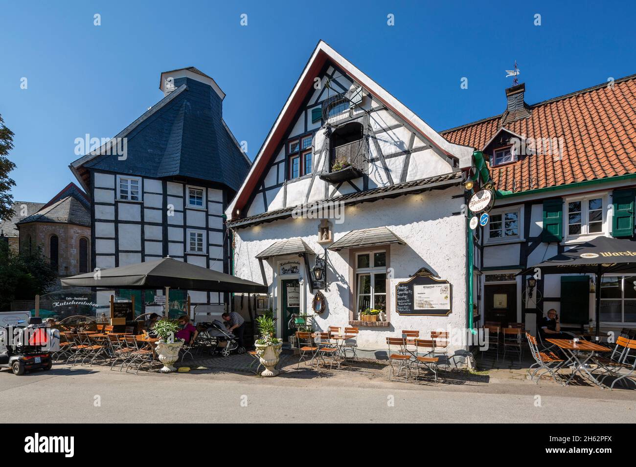 germany,wuelfrath,wuelfrath-duessel,bergisches land,niederbergisches land,niederberg,rhineland,north rhine-westphalia,dorfstrasse in the village of duessel,left half-timbered house eyser,eyserhaus,residential building,formerly kuesterhaus and school,right half-timbered building 'am iser' with restaurant and coaching room coffee shop Stock Photo