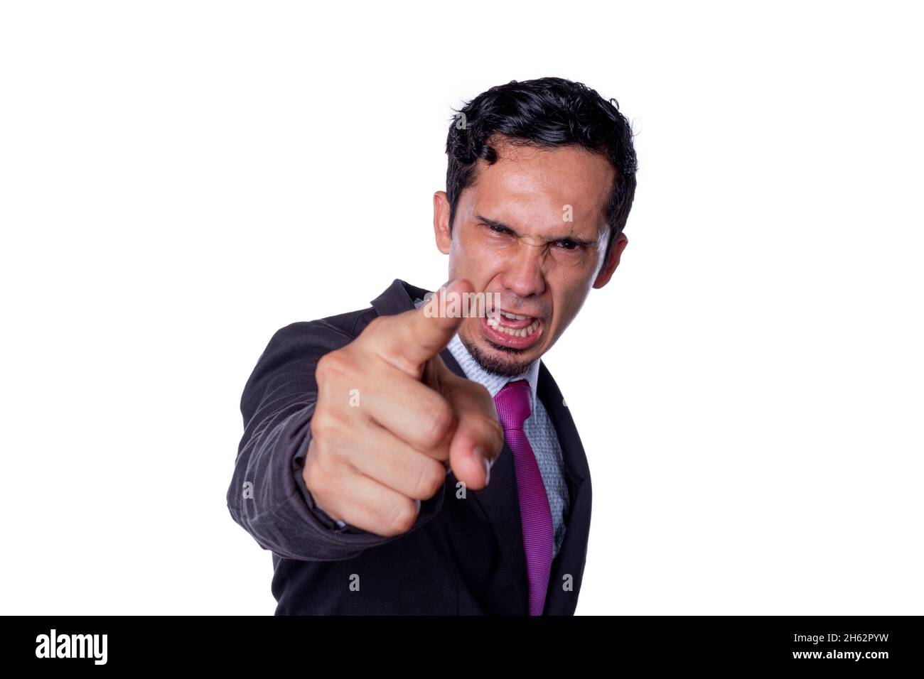 Very angry businessman boss scolding, shouting and pointing at the camera. Concept of an abusive and unpleasant boss. Angry man pointing index finger Stock Photo