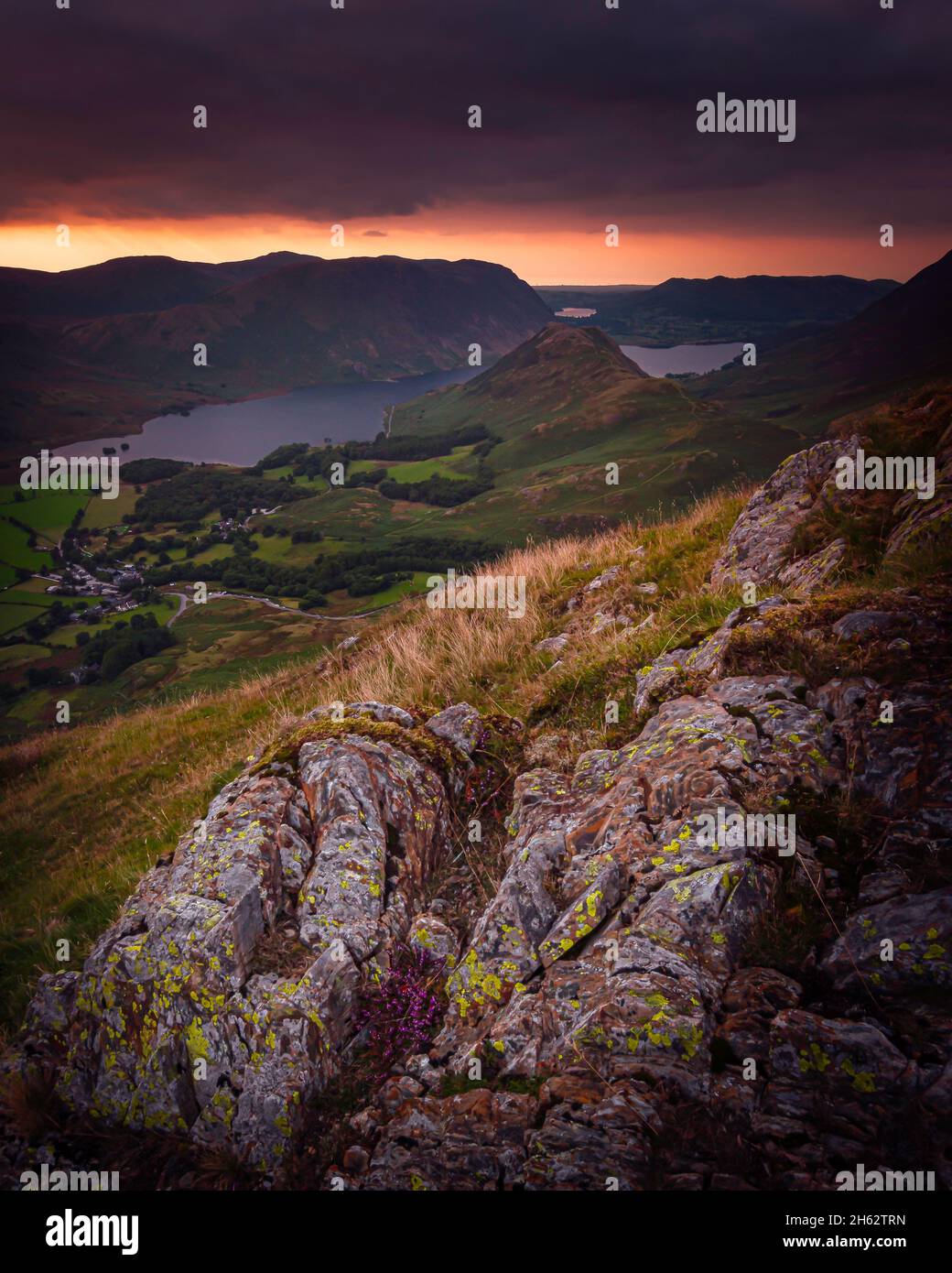 Dramatic sunset over mountains in Lake District.View from high up. Stock Photo
