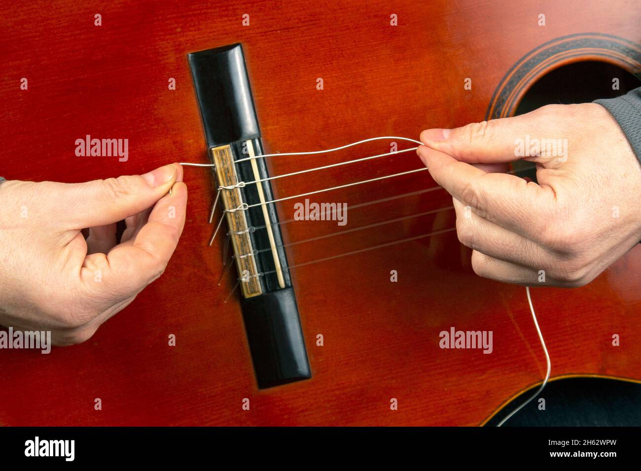 replacement and insertion of nylon strings in a classical guitar