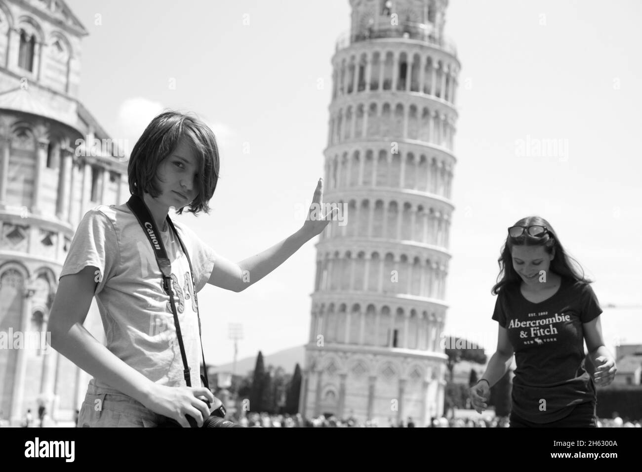 a typical tourist image of the leaning tower of pisa,toscany,italy,where the tourist looks as if he is supporting the tower. Stock Photo