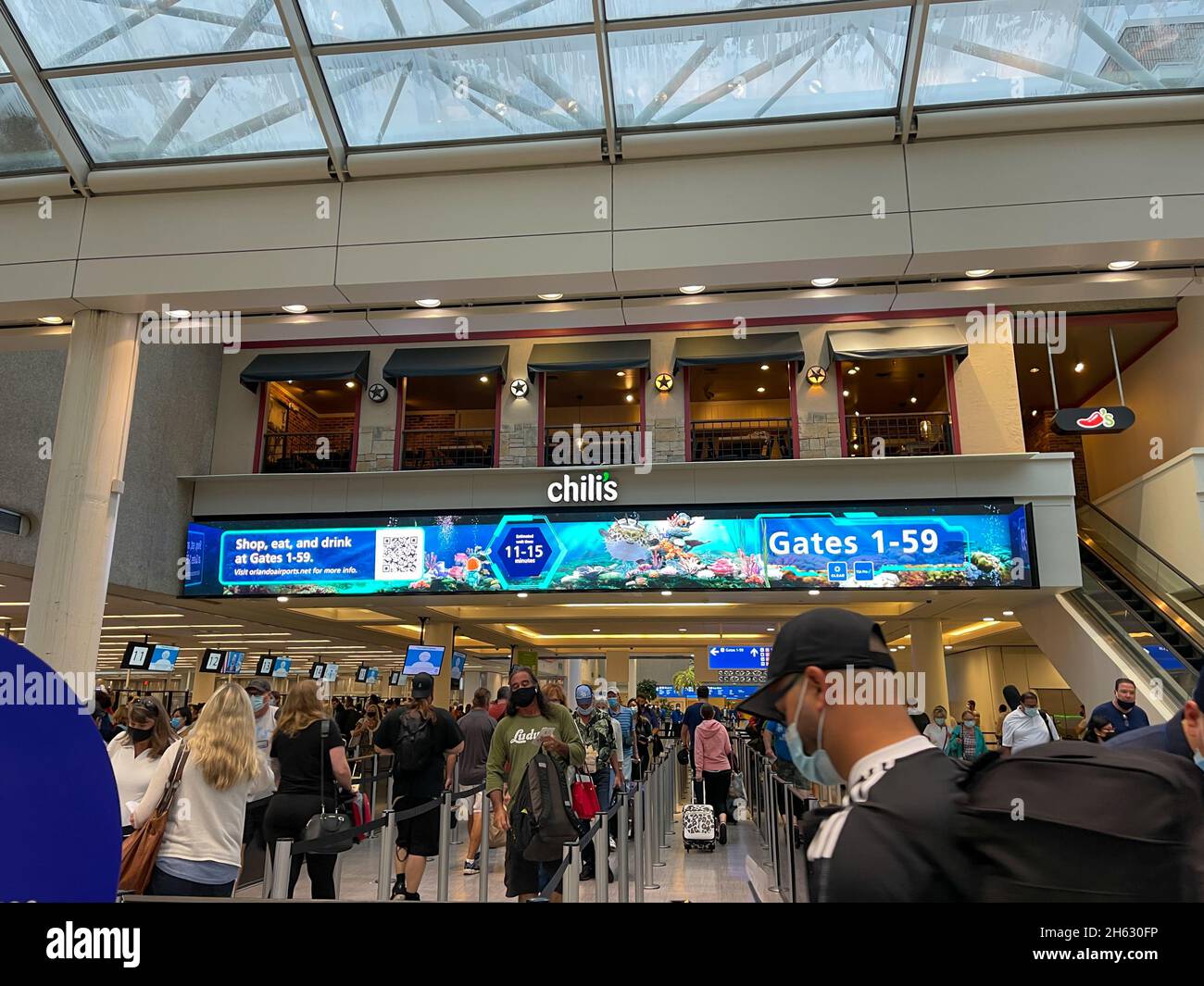 Orlando, FL USA - September 23, 2021:  People walking through the security line at Orlando International Airport MCO. Stock Photo