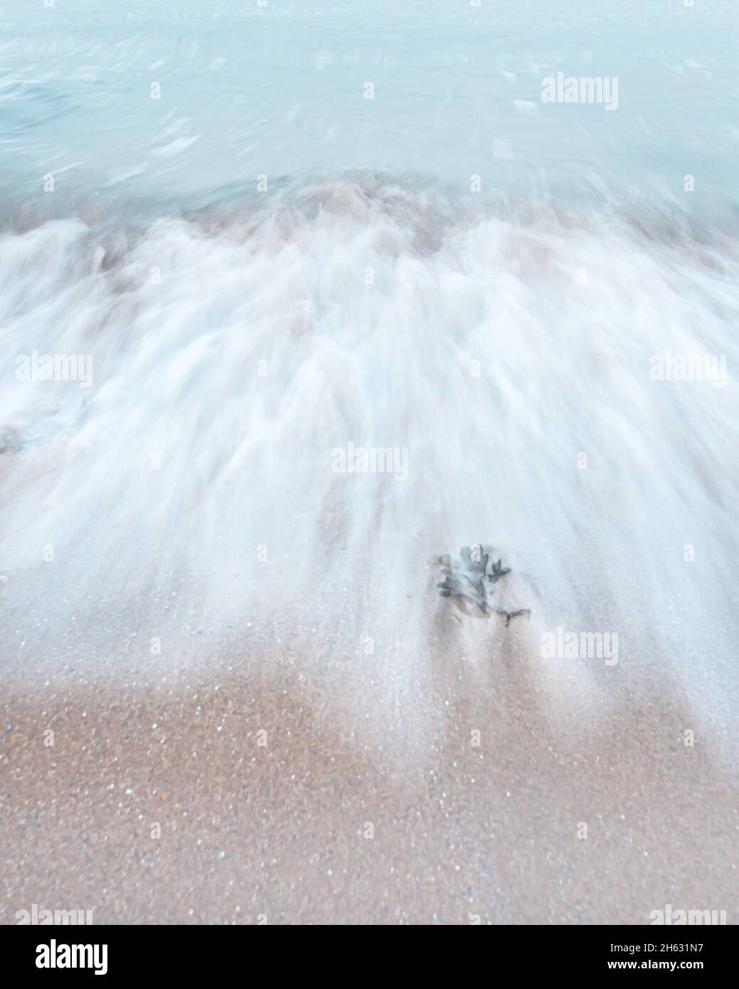 The wave splashing on sandy beach.Minimalist seascape abstract photo. Stock Photo