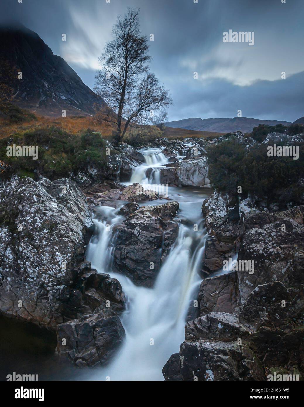 Waterfall and lone tree on river Etive in Glencoe, Scottish Highlands. Stock Photo