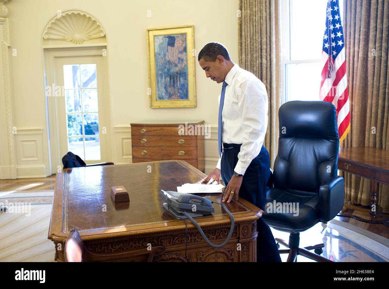 Jan. 21, 2009  - This was his first morning in the Oval Office as President of the United States. He was reading some briefing material before a meeting Stock Photo