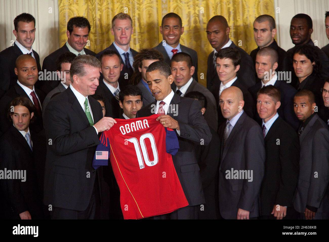President Barack Obama is presented with a team jersey by Real Salt Lake team chairman Dave Checketts during a ceremony honoring the Major League Soccer champions in the East Room of the White House, June 4, 2010. Stock Photo