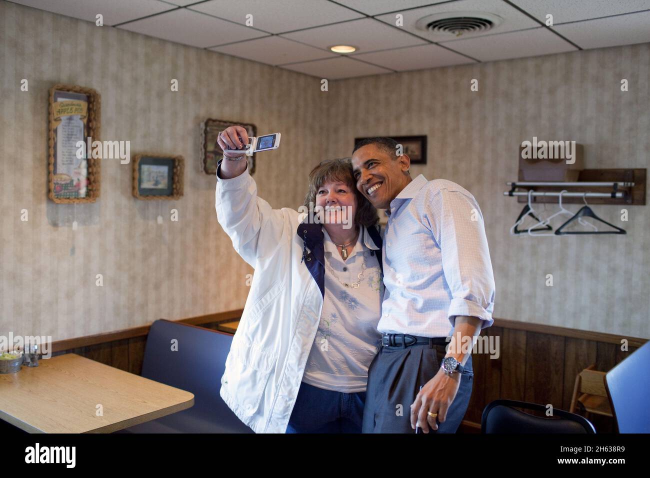 President Barack Obama poses for a photo with a patron at Jerry's Family Restaurant, a diner in Mount Pleasant, Iowa, April 27, 2010. Stock Photo