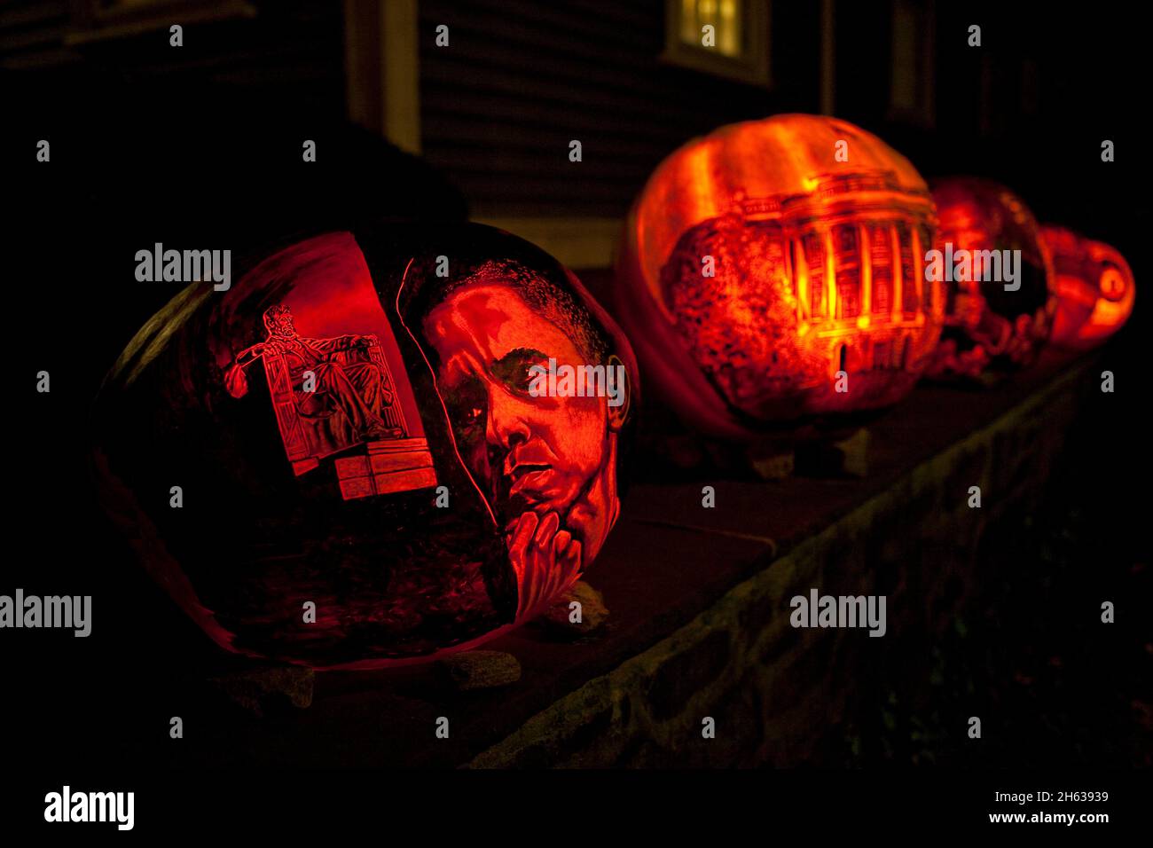 Carved pumpkins depicting President Barack Obama, Abraham Lincoln, and the White House decorate the outside of a home in Providence, R.I., Oct. 25, 2010. Stock Photo