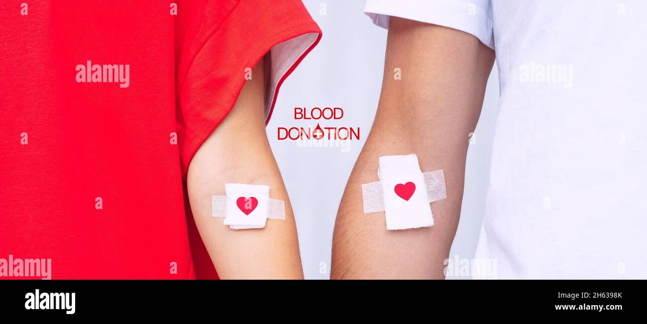 Blood donors with bandage after giving blood. Blood donation, save lives. World blood donor day concept Stock Photo