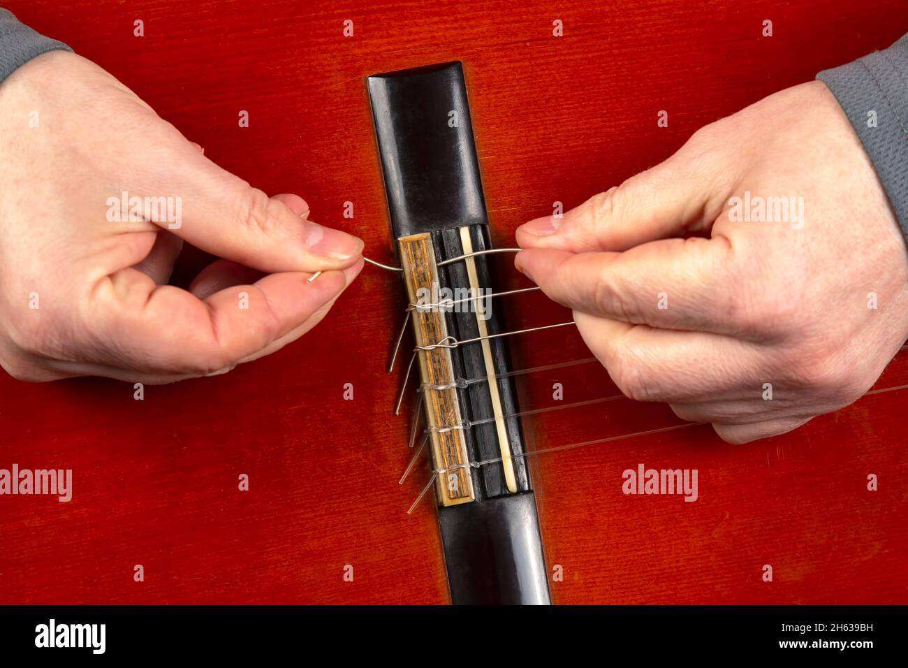 replacement and insertion of nylon strings in a classical guitar