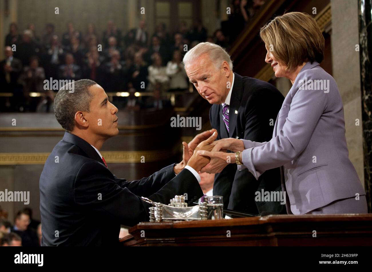 President Barack Obama shakes hands with Vice President Joe Biden and Speaker of the House Nancy Pelosi at the conclusion of his State of the Union address, Jan. 27, 2010 Stock Photo