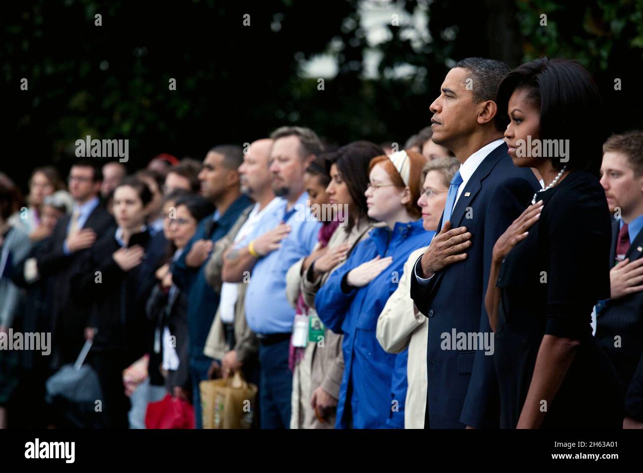 President Barack Obama and First Lady Michelle Obama stand with White House staff members on the  South Lawn of the White House as they observe a moment of silence marking the eighth anniversary of the Sept. 11 attacks, Sept. 11, 2009 Stock Photo