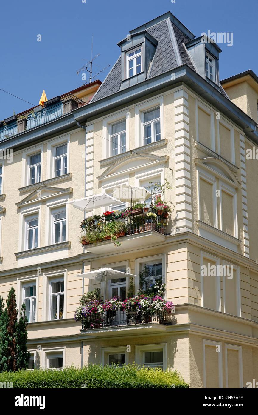 germany,bavaria,munich,town house,old building,wilhelminian style,facade,apartment,balconies with flowers Stock Photo